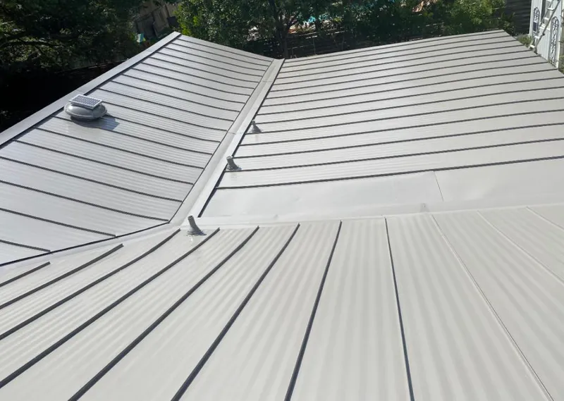 Solar attic fan installed on a metal roof for Roof Ventilation in Robinwood